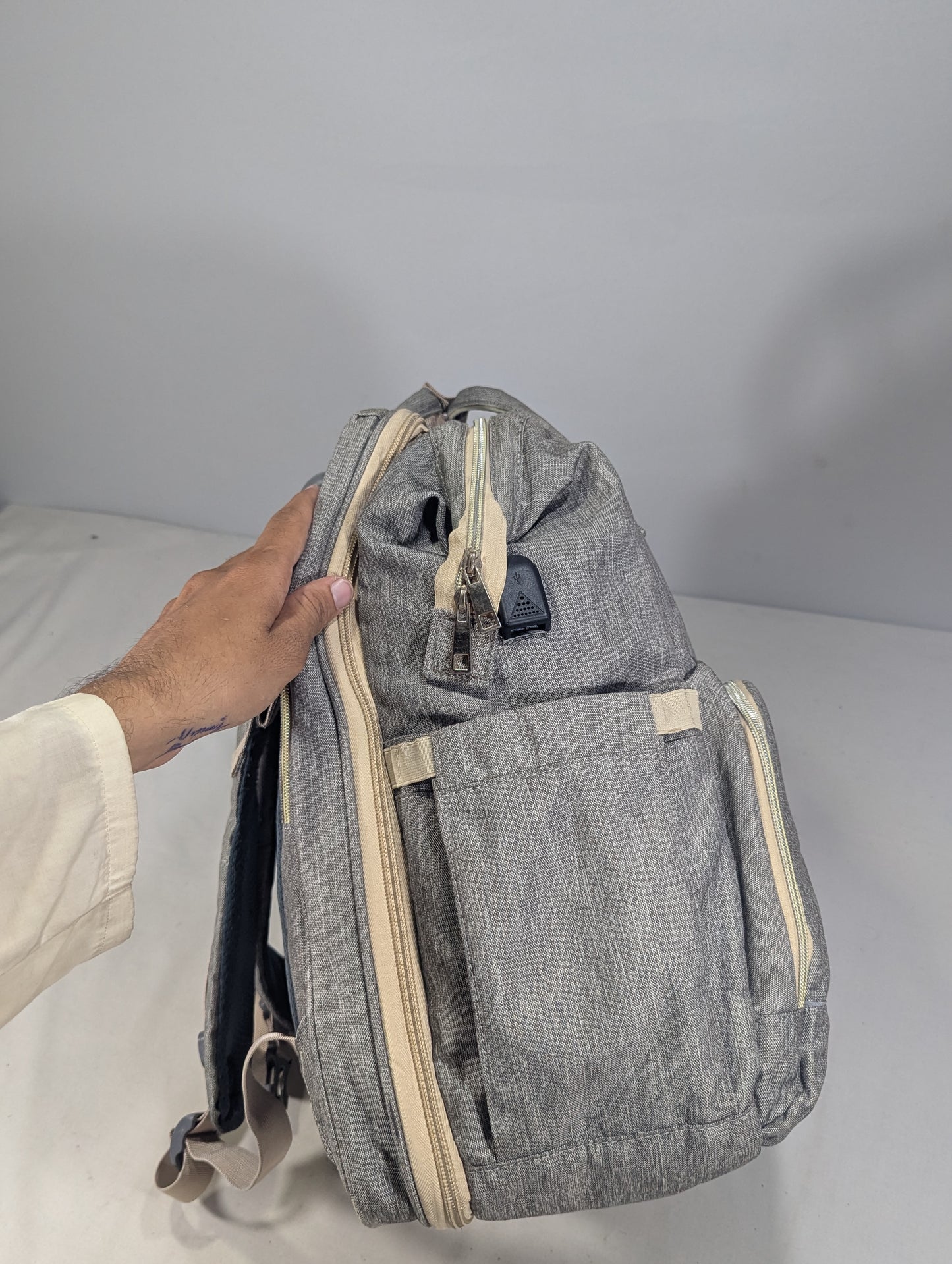 Grey color baby diaper backpack with bed